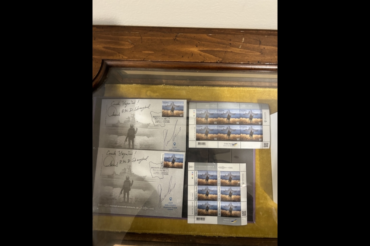 A pile of signed stamp-sized photos.