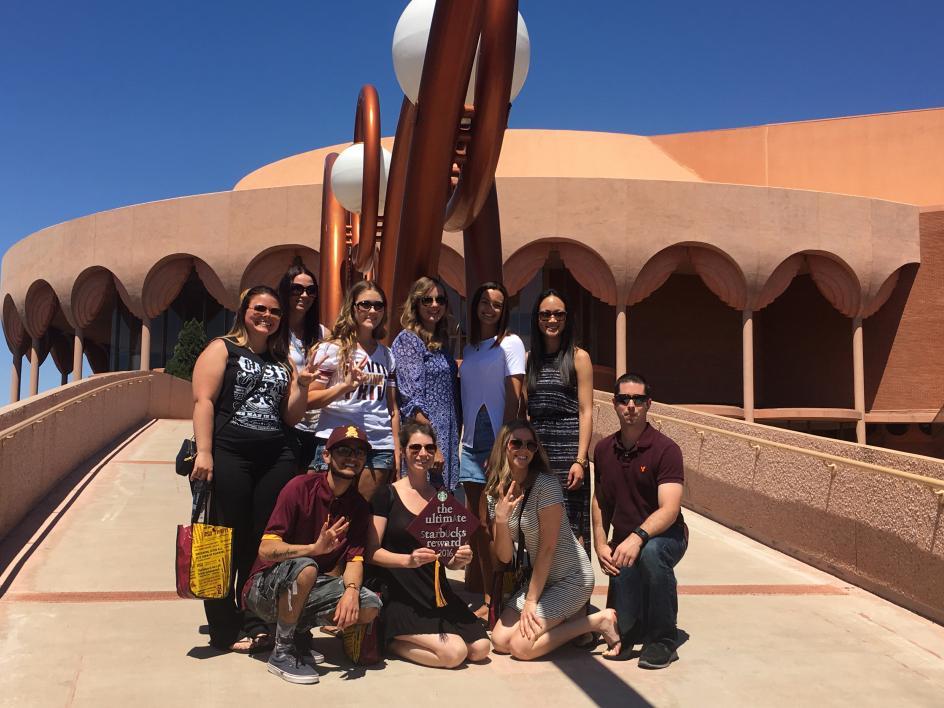students posing in front of Gammage