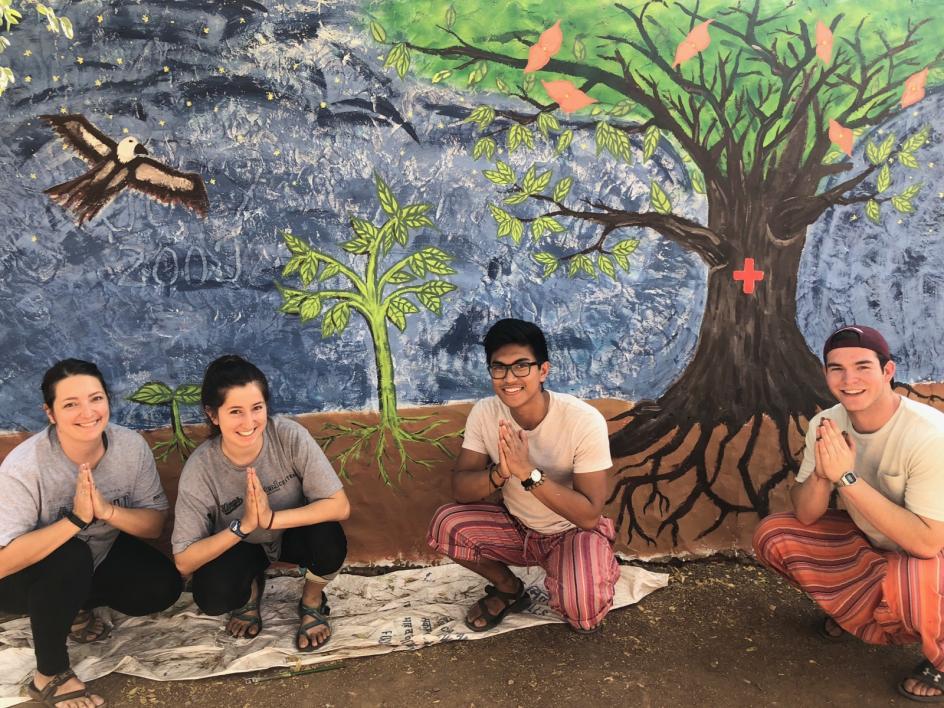 Kirra with 3 other students in front of a mural project in India.