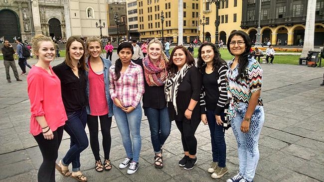 ASU students studying abroad pose for a photo in a plaza in Lima, Peru
