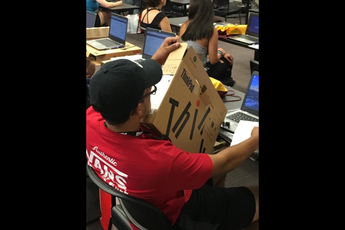 ASU Bridging Success student examines Think Pad box for serial number