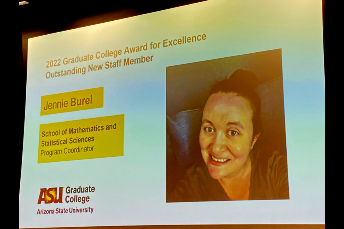 Presentation slide projected on a screen featuring a portrait of ASU staff member Jennie Burel.