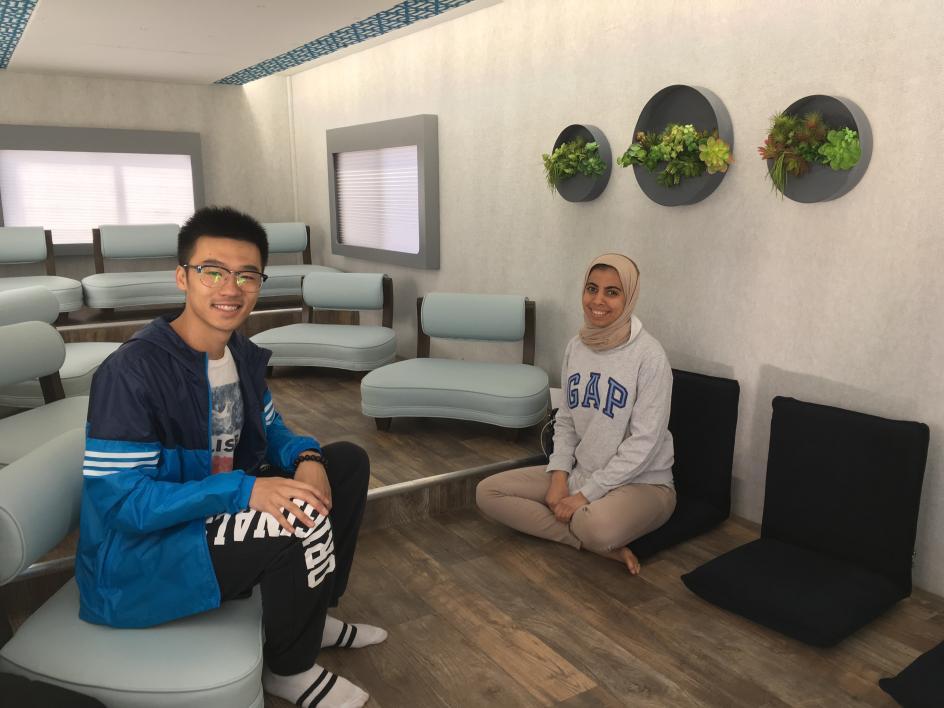 Two students sit inside the M2 Mobile Mindfulness Studio