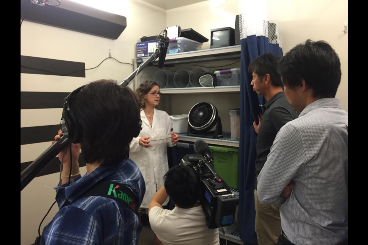 woman showing lab to film crew