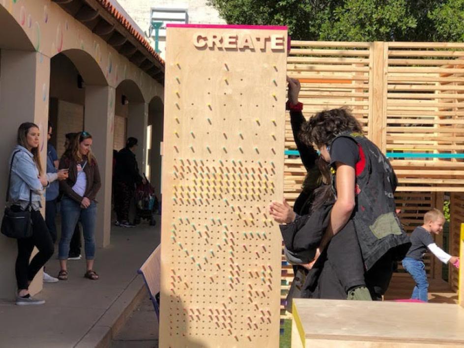 Visitors explore the Inter PLAY installation on display in downtown Mesa.