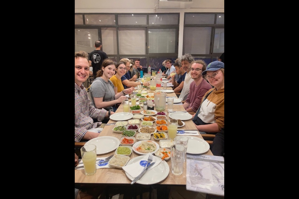 group of people eating at long table