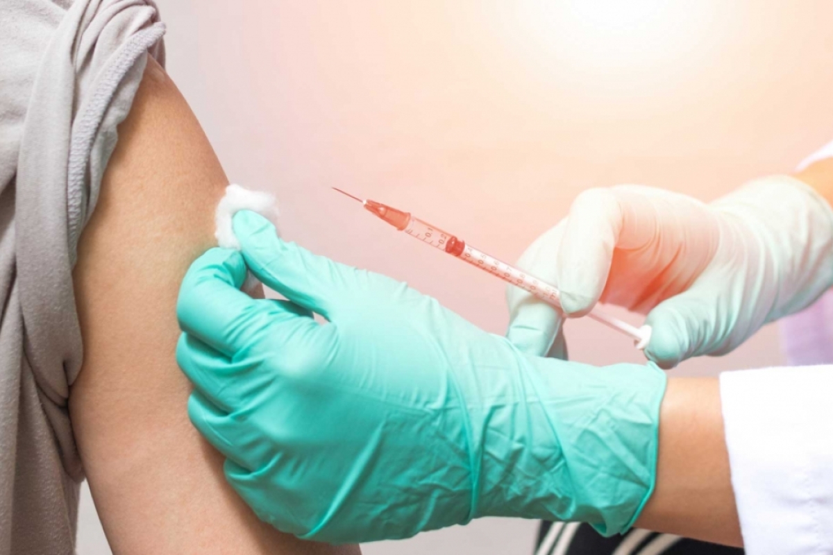 A person gets a shot in their upper arm