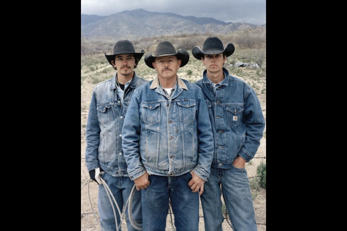 Photo by Pam Golden shows three white men wearing black cowboy hats and denim jackets.