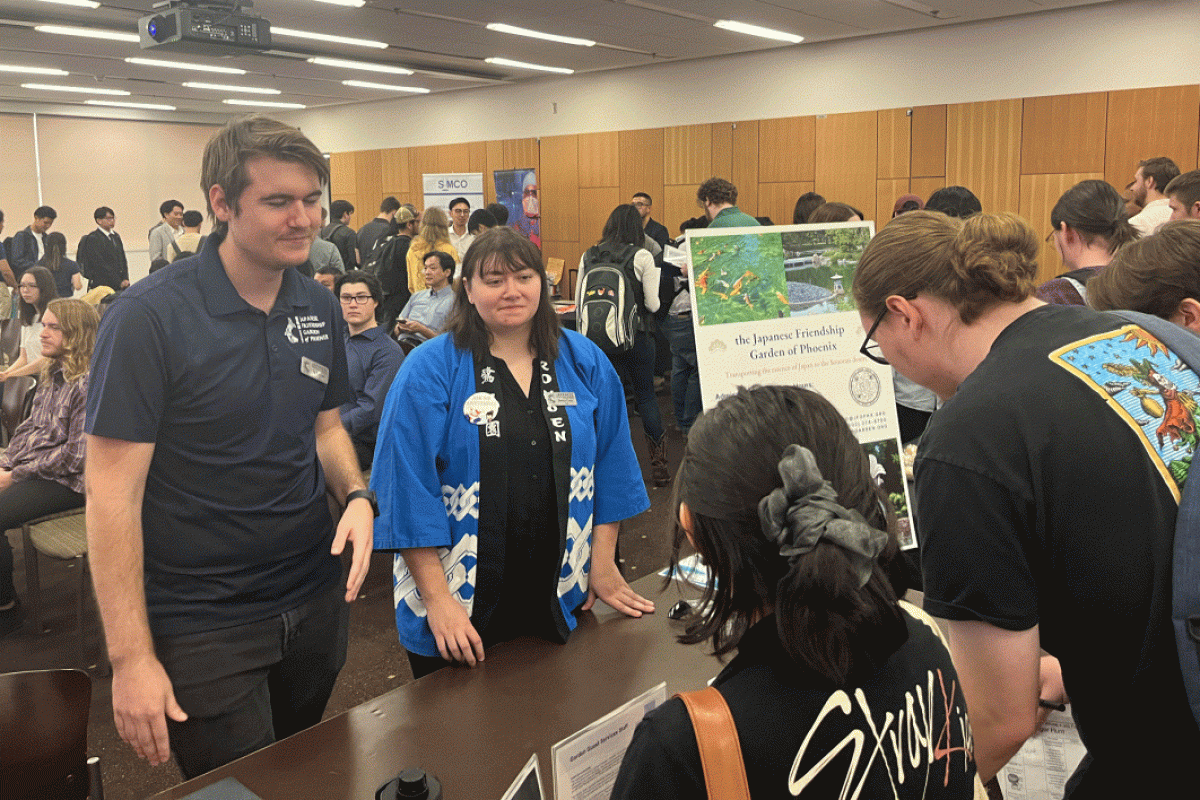 People speak to others at a tabling event