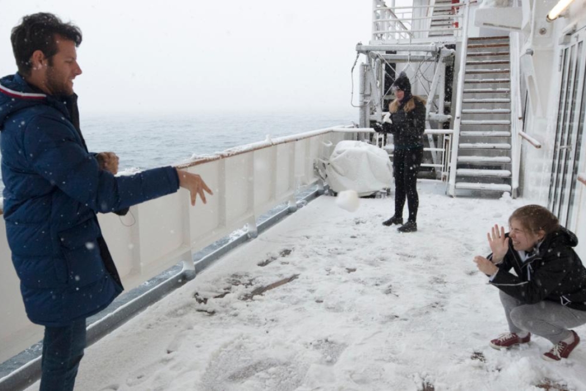 Group of ASU students in a snowball fight aboard the ship in Antarctica