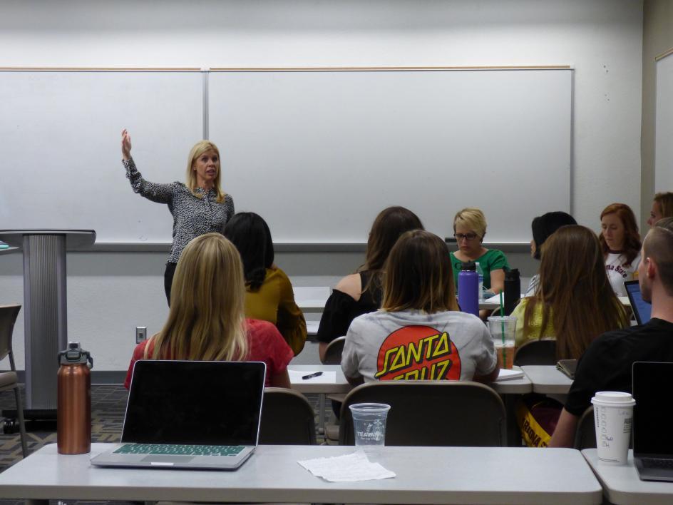 Picture of Karissa Greving Mehall speaking to her class of students