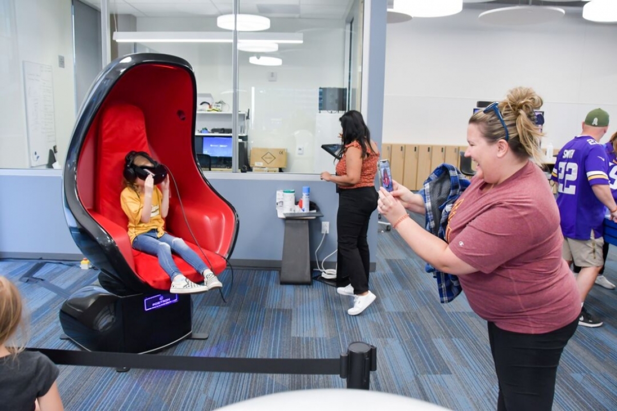 Attendees shown trying out the Positron Chair.