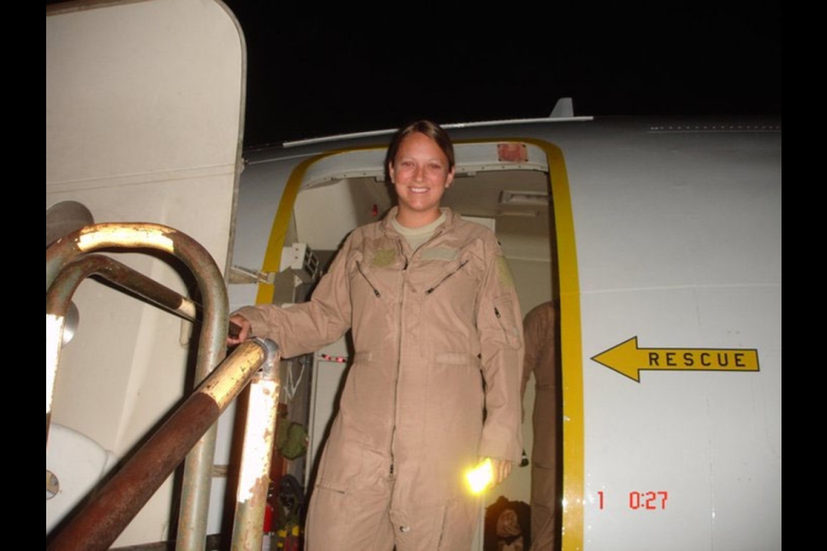 woman stepping out of military plane