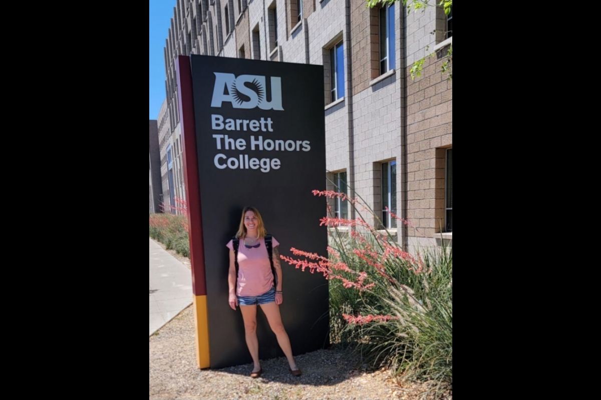 Richards standing in front of the ASU Barrett: The Honors College sign