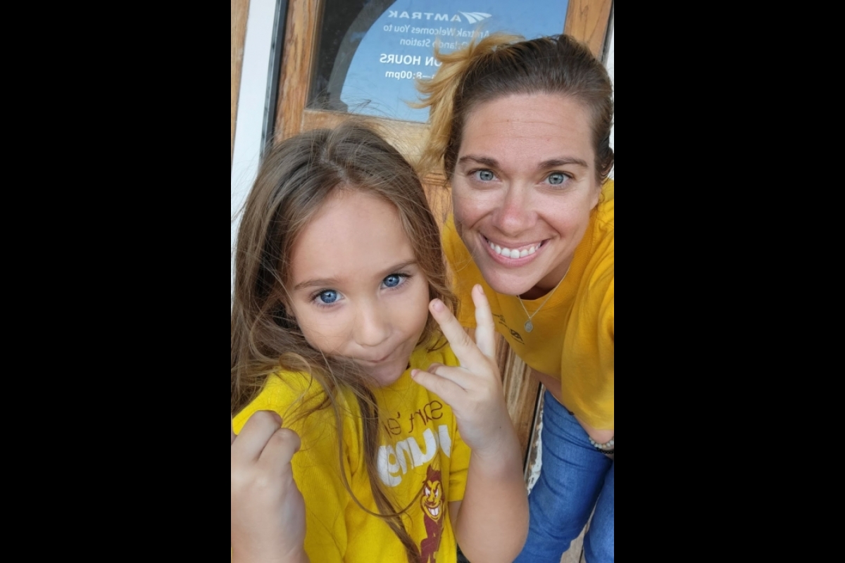Richards and her daughter wearing ASU gold and smiling at the camera