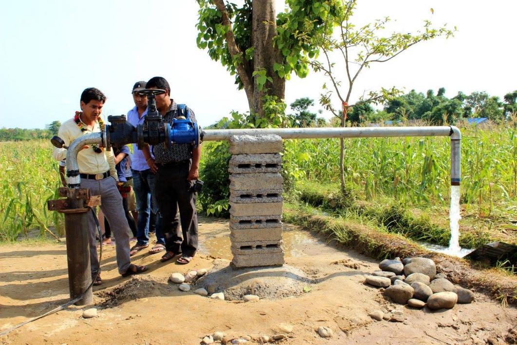 Nepali farmers work on irrigation system