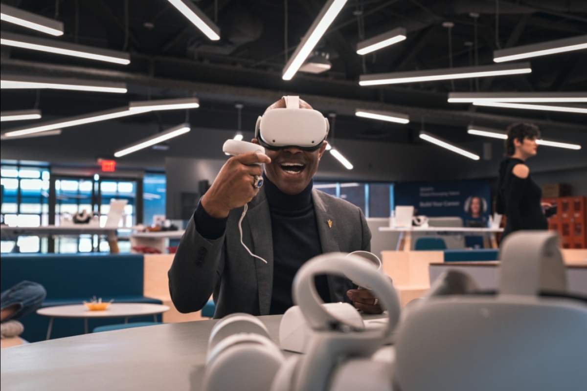 Man in suit is wearing a virtual reality headset with a smile