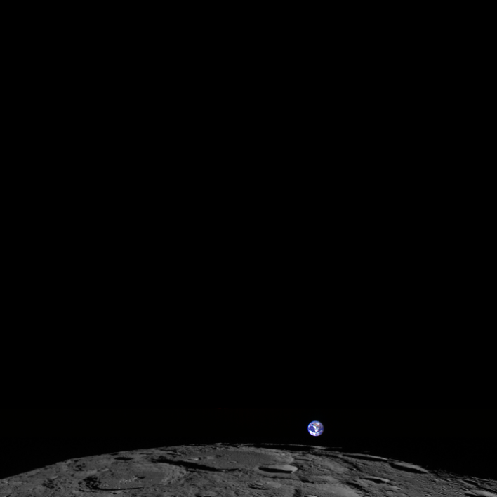 A photo of the Earth rising over the edge of the moon.