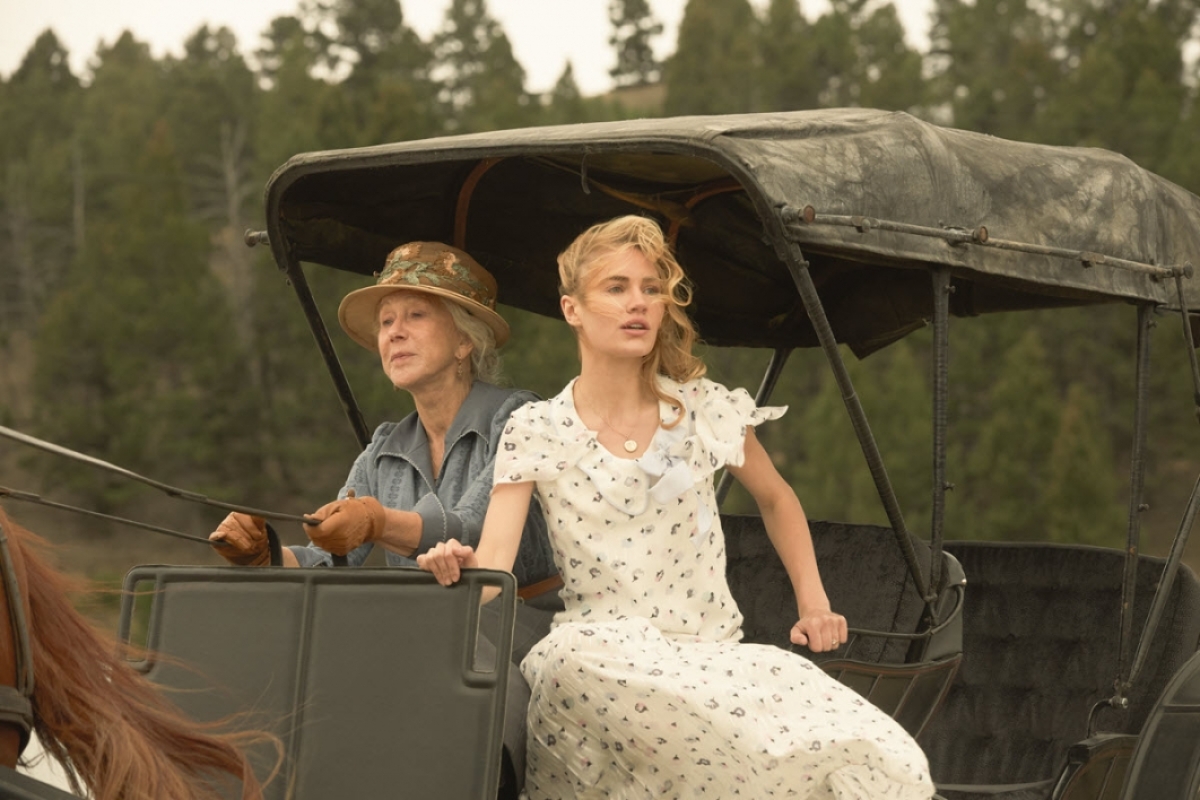 Actresses Helen Mirren and Michelle Randolph drive a horse and buggy.