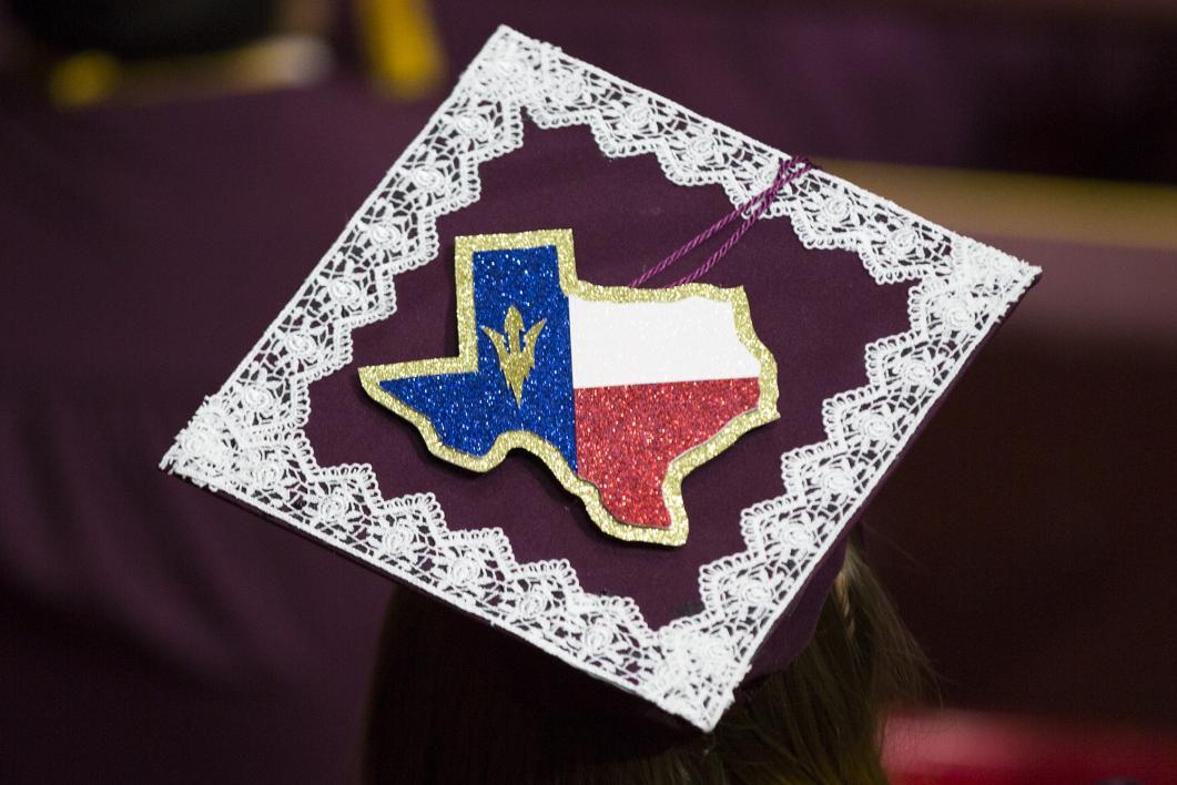 A graduation cap shows Texas in appropriately colored rhinestones