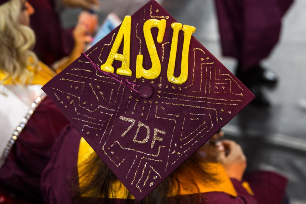 A graduation cap is covered in glitter lines and the text, "7DF"