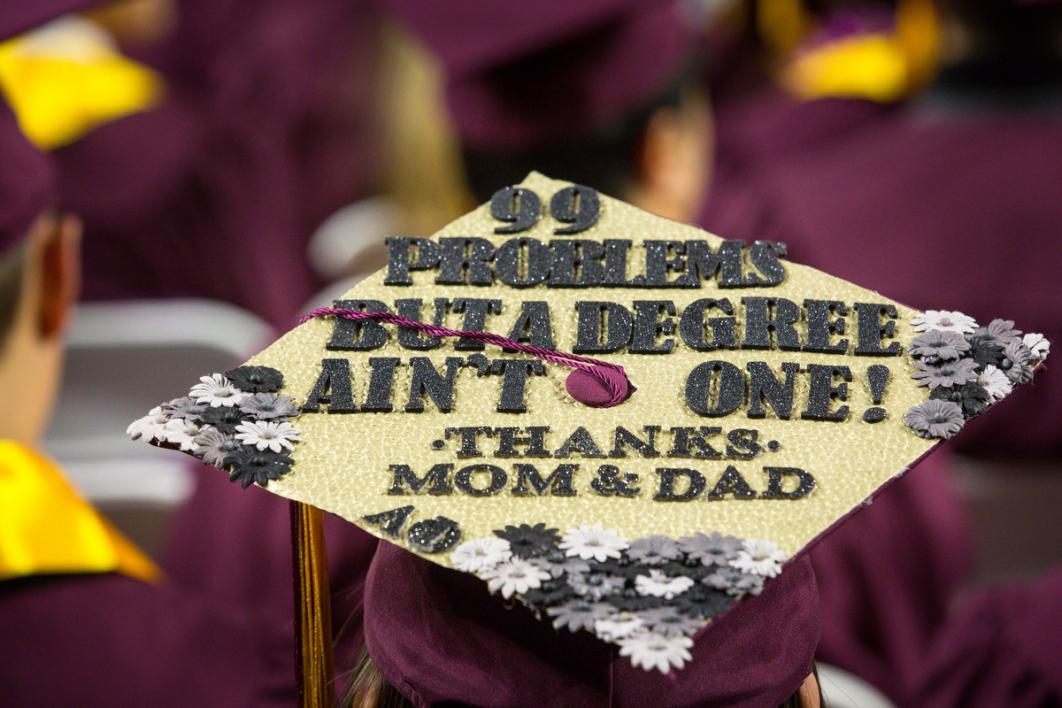 Another graduation cap reads a modified Jay-Z lyric: "99 problems but a degree ain't one"