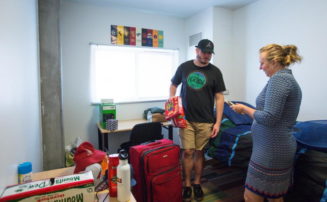 A new student and his mom unpack his things in his downtown Phoenix dorm room.