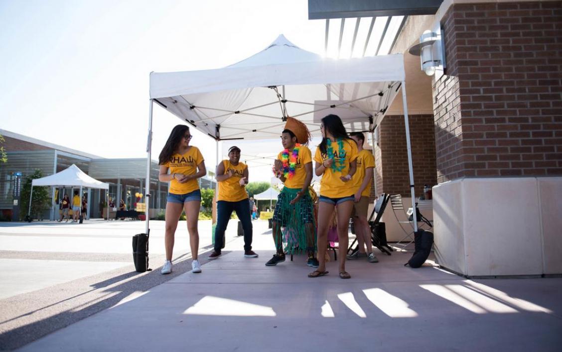 Student helpers dance while waiting for students to arrive to move-in.