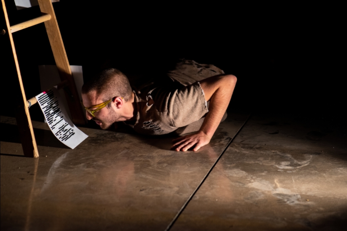 man reading from paper while lying on the floor