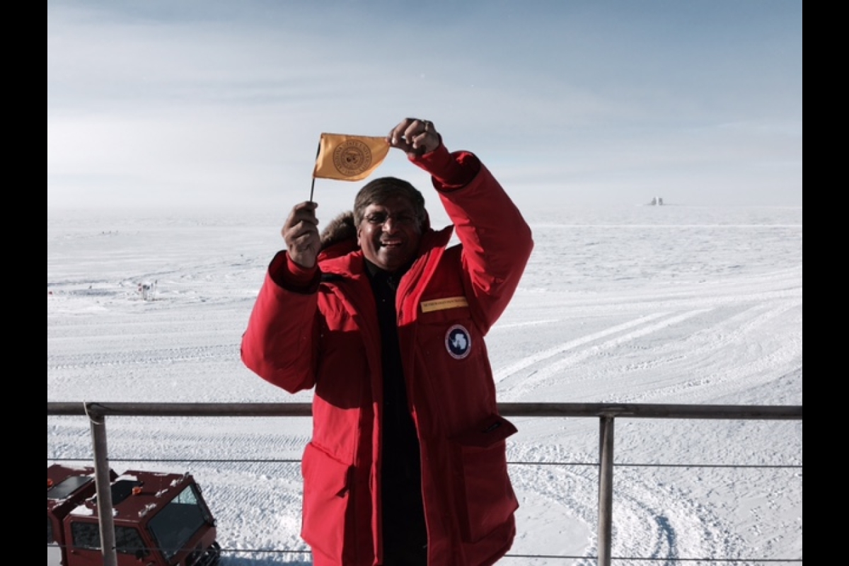 man waving a flag in Antarctica