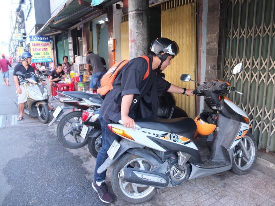 A man parks a motorbike on the street in Ho Chi Minh City.