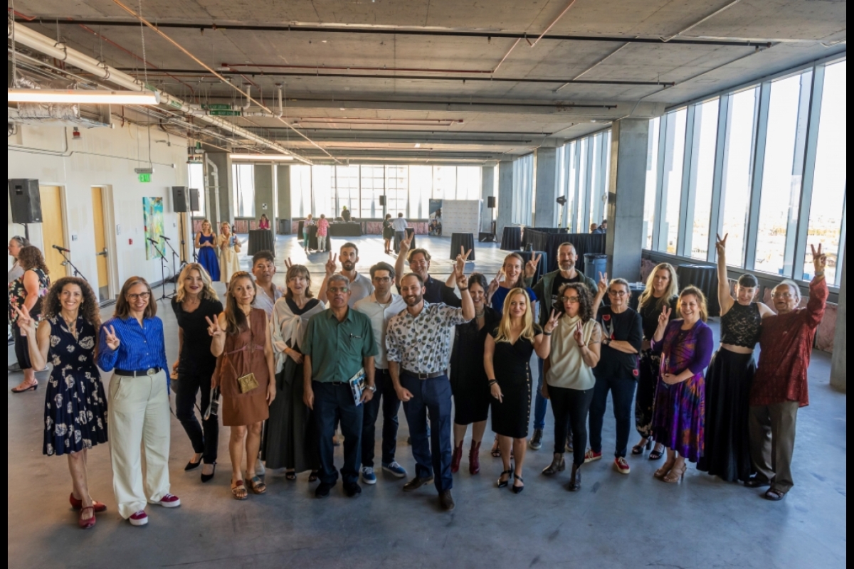 Group photo of artists and researchers inside a building at the Phoenix Bioscience Core.