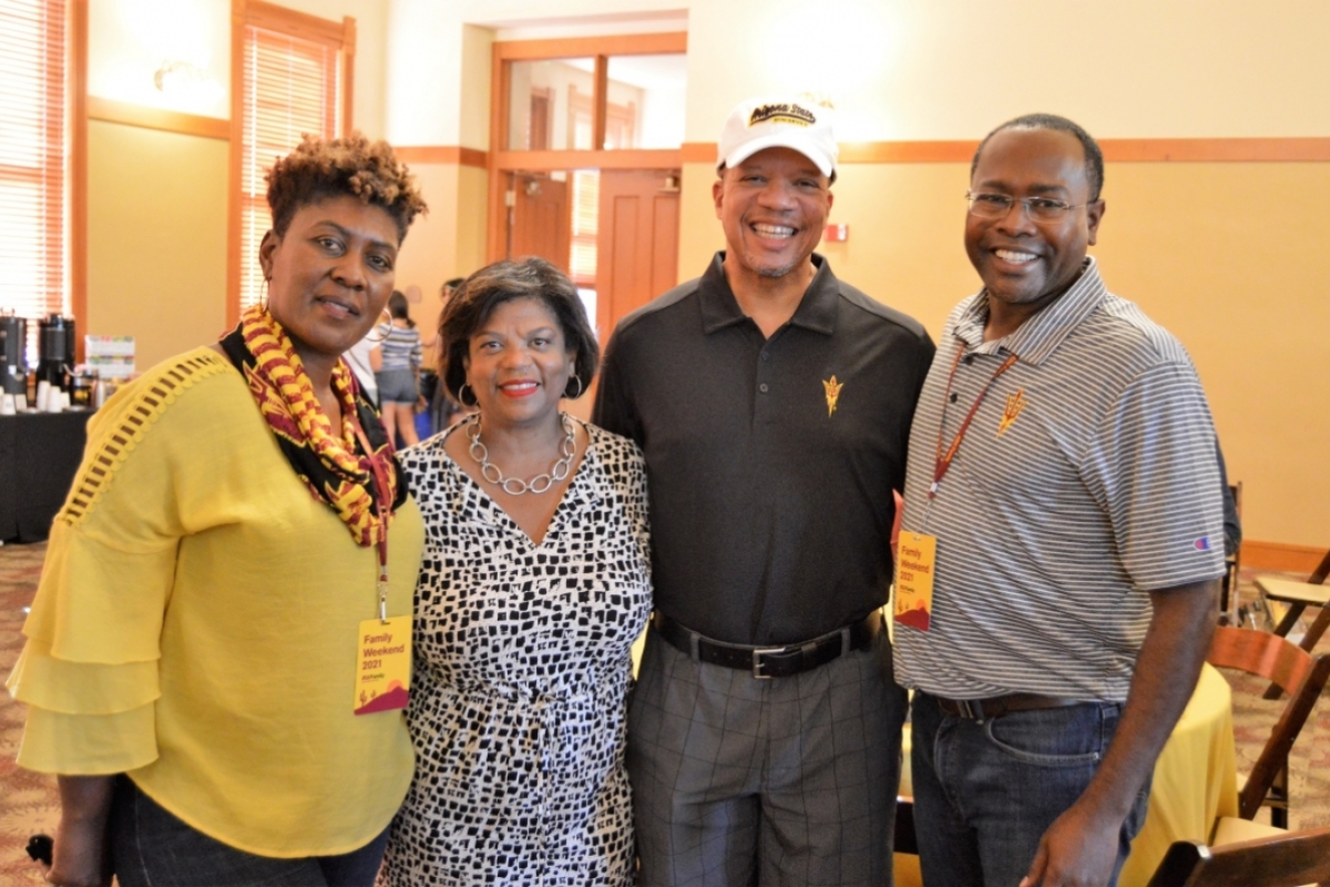 Four family members pose for a photo during the ASU Family People of Color Coffee Connection during Family Weekend.
