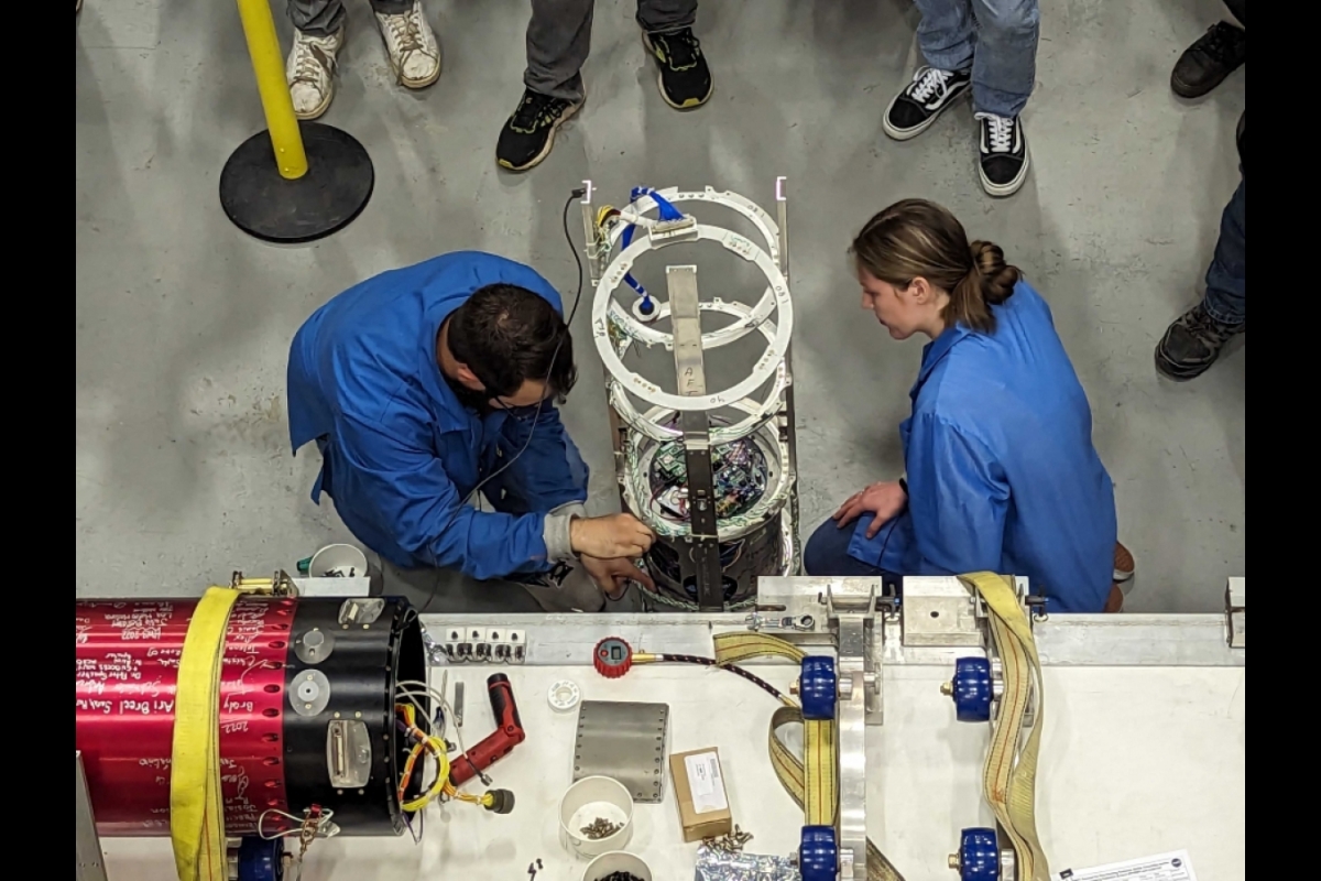 Scientists CanSat testing hardware for a rocket.