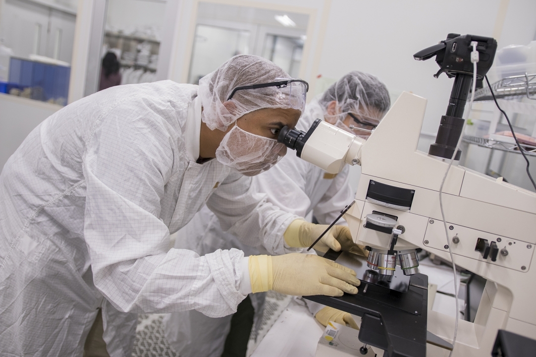scientists looking into microscopes at ASU's QESST Photovoltaic Research Center