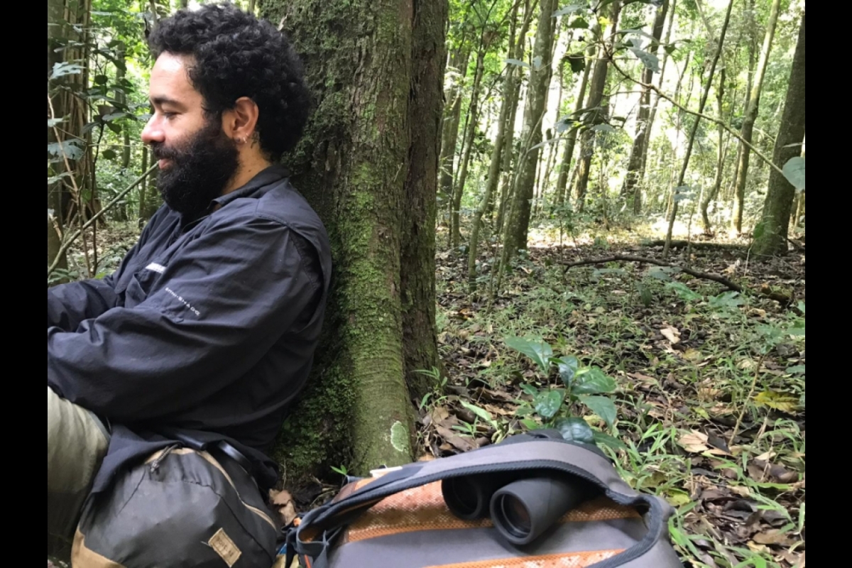 Sebastían Ramírez Amaya leans against a tree in the forest
