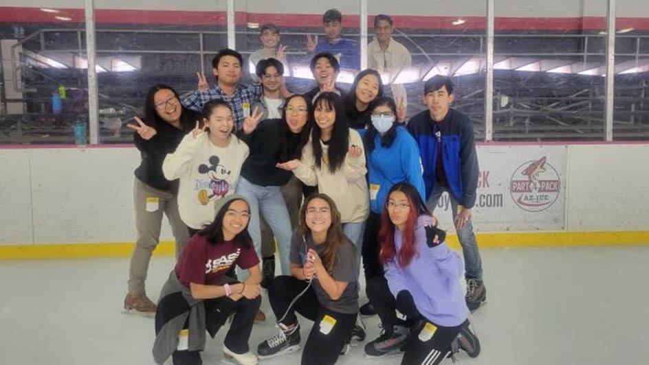 Students pose for photo on ice rink