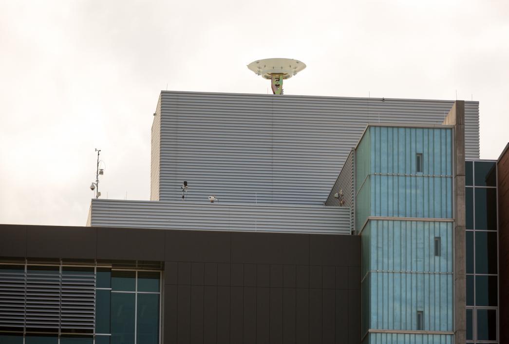view of satellite dish on top of building from the ground
