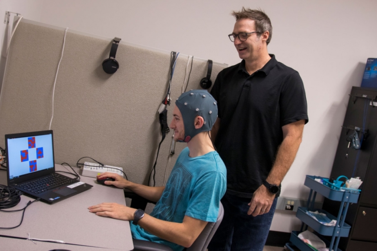 Associate Professor William “Jamie” Tyler (standing) works with a student in the Tyler Neurotechnology Lab.