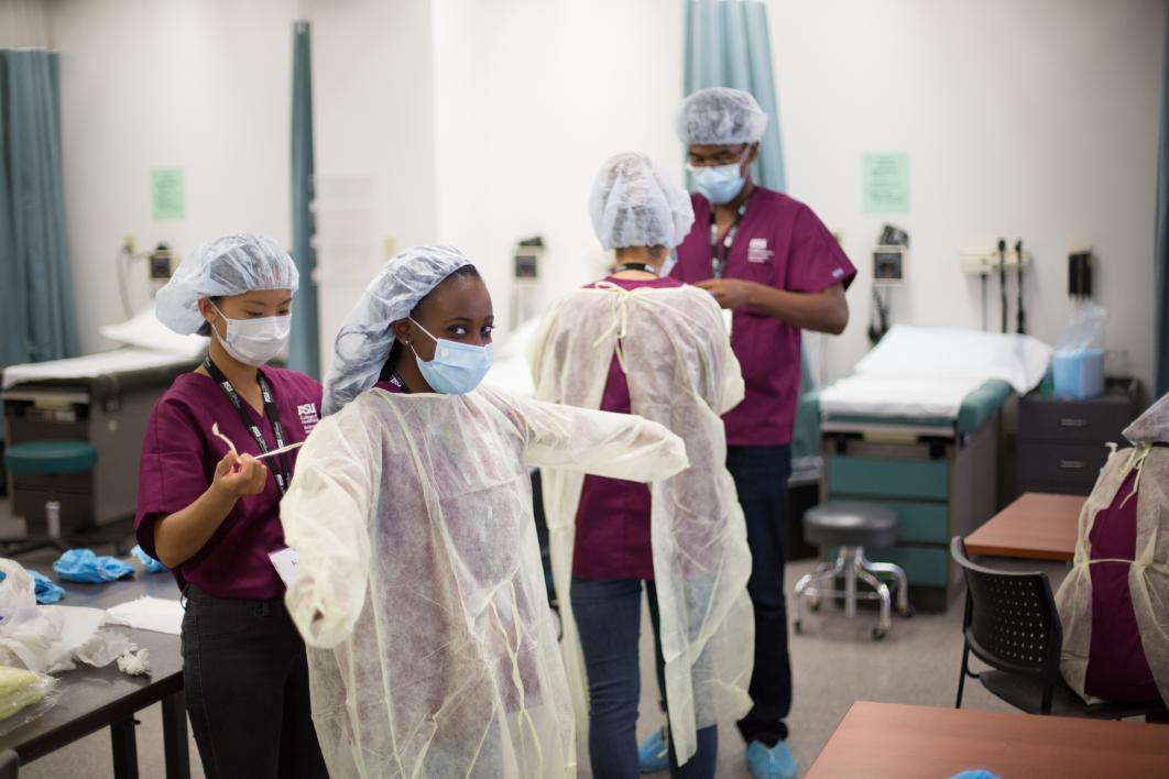 students put on medical gown