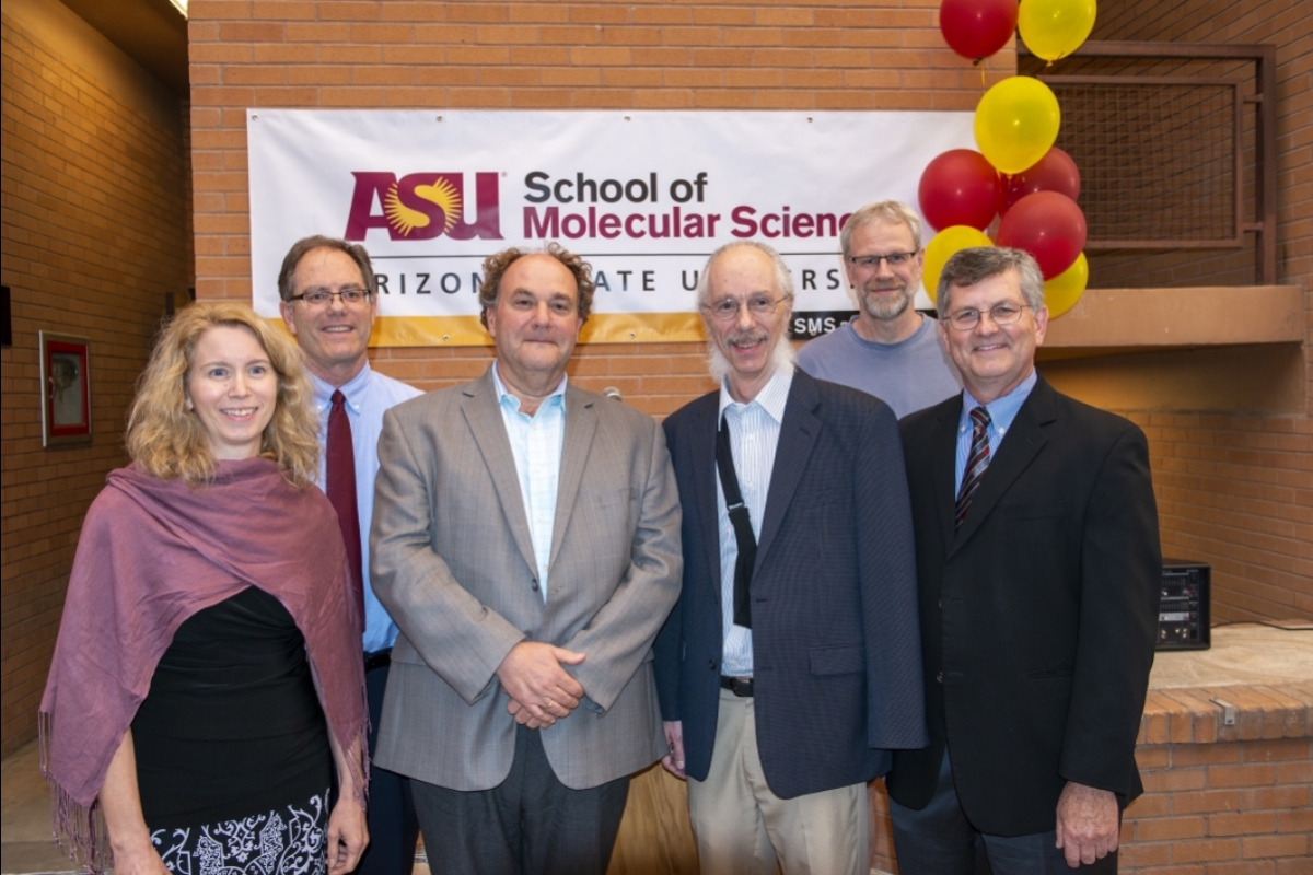Faculty pose for a group photo in front of a banner that reads: School of Molecular Sciences.