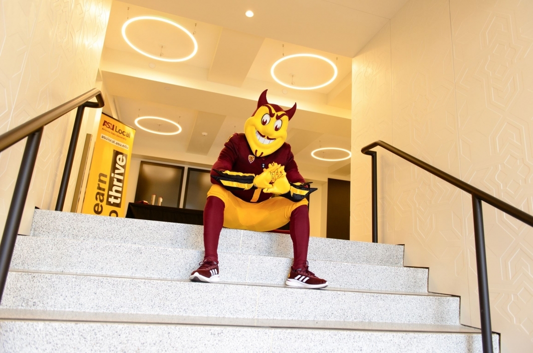 Sparky sitting on a stairway inside the Herald Examiner building.
