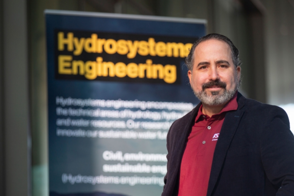 Enrique Vivoni in front of a banner that says Hydrosystems Engineering.
