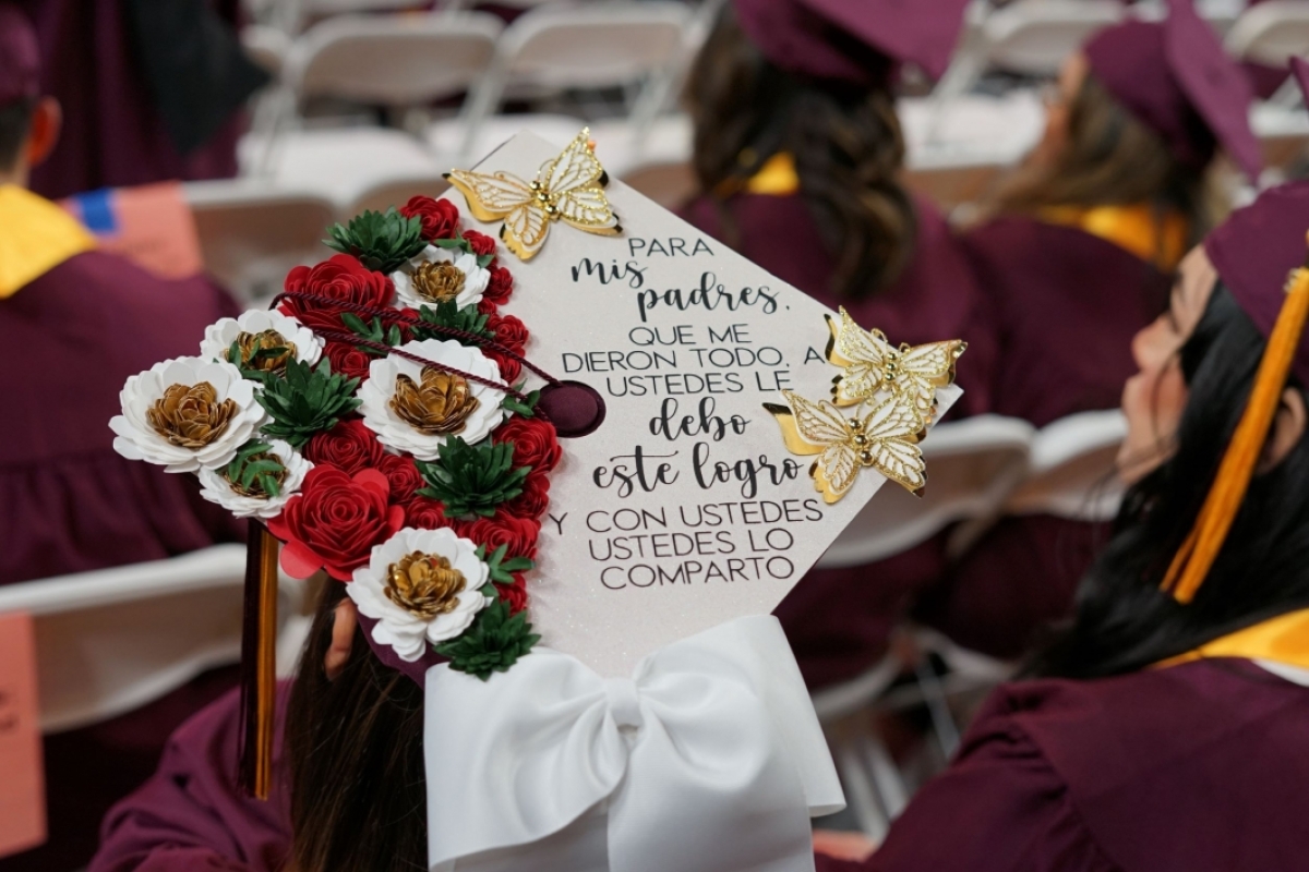Mortarboard decorated with flowers and the words 
