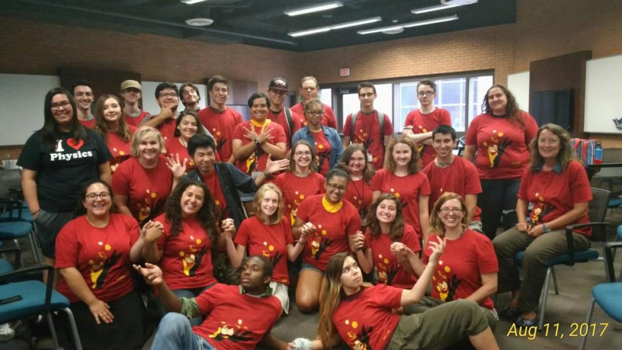 group of people wearing red shirts posing for photo