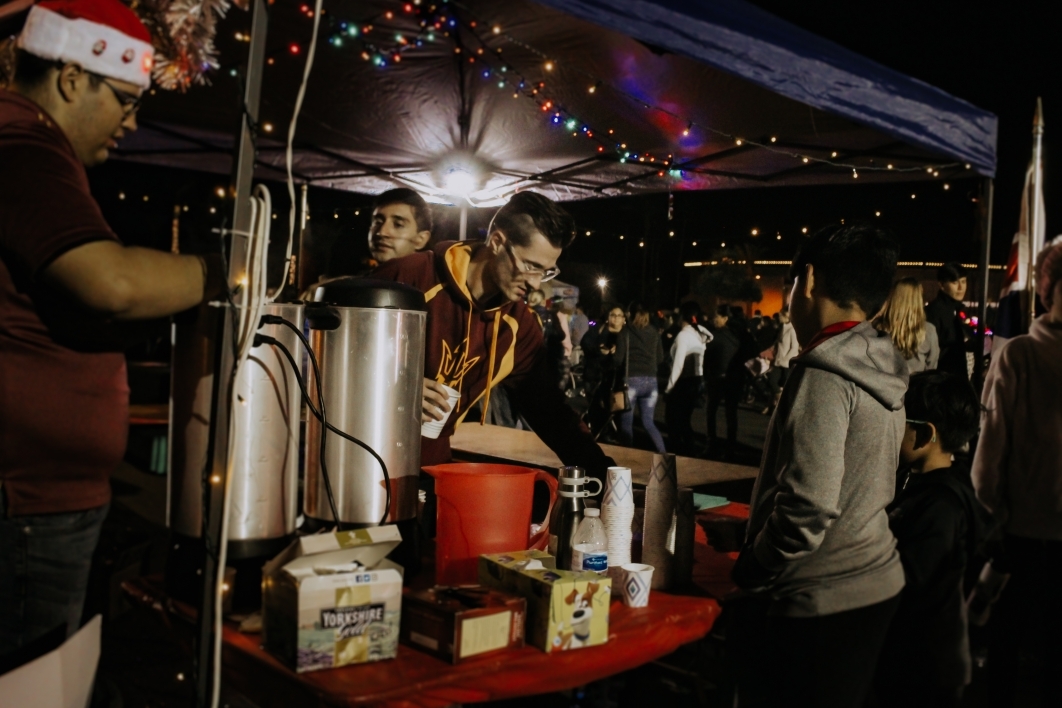 students serving tea and cocoa