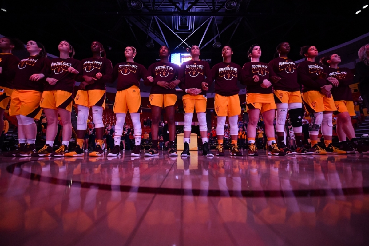 The ASU women hoops team stands in a line on the court
