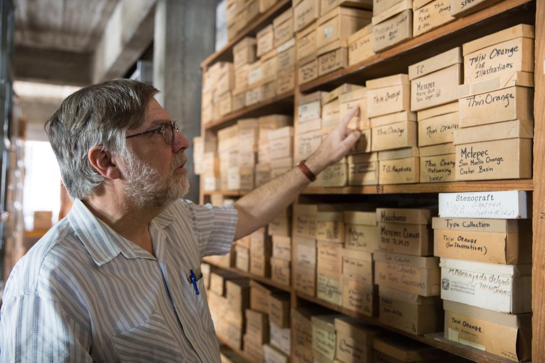 The lab director goes through the stacks at the Teotihuacan Research Laboratory
