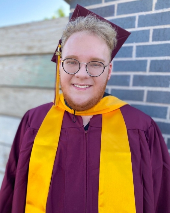 portrait of ASU's College of Health Solutions graduate Adam Thompson wearing his graduation cap and gown