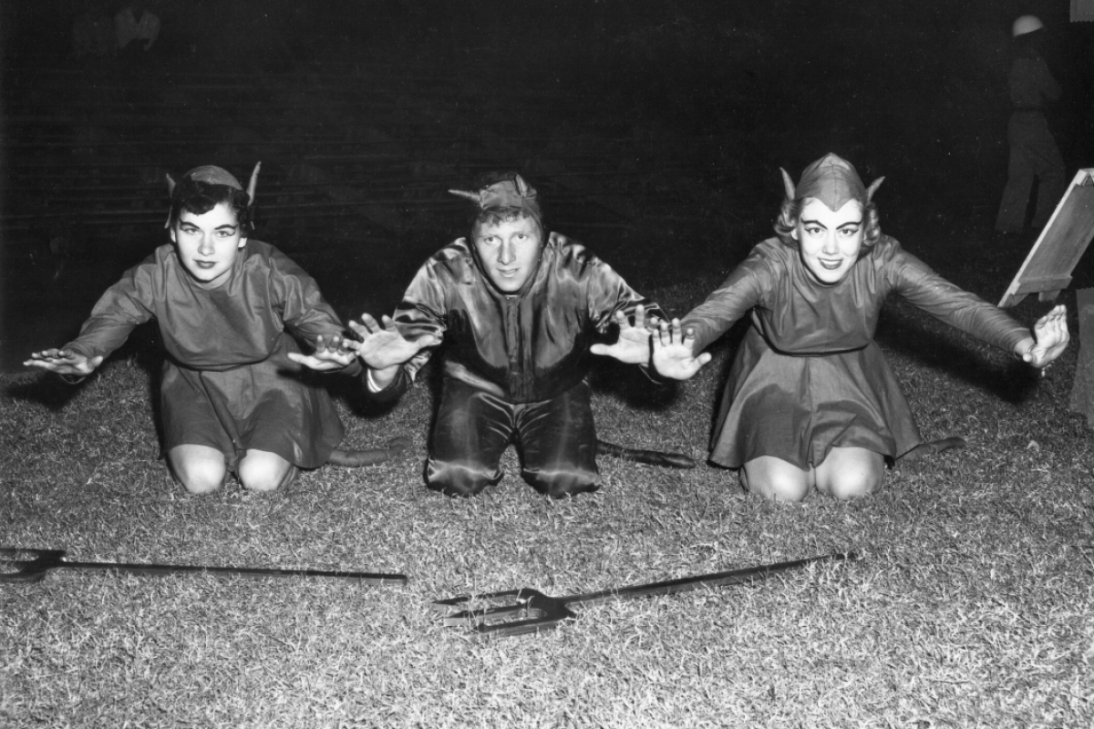 The very first Sun Devil mascot is flanked by the two Sparkettes in a photo from the early 1950s